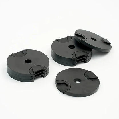 Four black plastic components on a white background